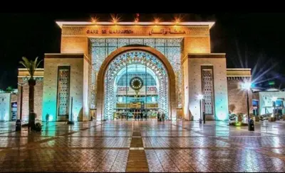 a large building with a lit up facade at night at Appartement gueliz 30 in Marrakech