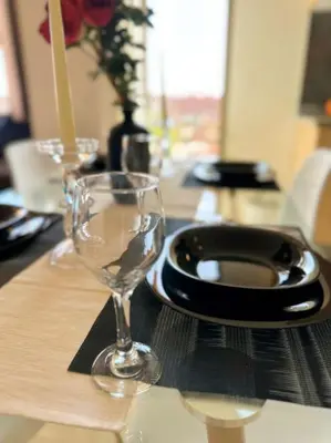 a table with a plate and a wine glass on it at Appart Majorelle terrasse wifi centre ville in Marrakech