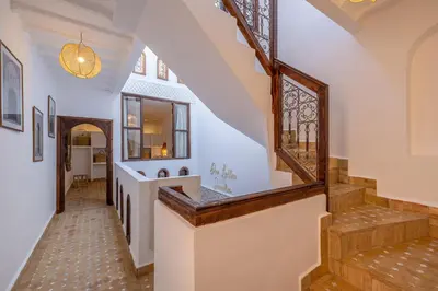 a hallway of a home with stairs and windows at Riad Dar Lalla Saadia-Exclusiv-HeatedPool-Breakfast in Marrakech