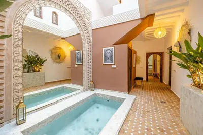 a pool in the middle of a house at Riad Dar Lalla Saadia-Exclusiv-HeatedPool-Breakfast in Marrakech