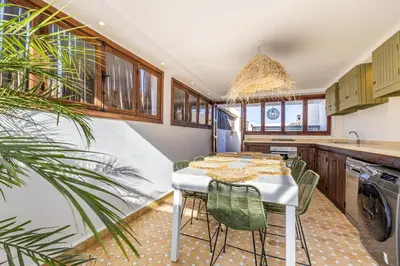 a kitchen with a table with chairs and a sink at Riad Dar Lalla Saadia-Exclusiv-HeatedPool-Breakfast in Marrakech
