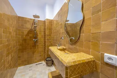 a bathroom with a sink and a mirror at Riad Dar Lalla Saadia-Exclusiv-HeatedPool-Breakfast in Marrakech