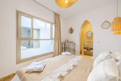 a bedroom with a large bed and a window at Riad Agan Exclusive with New Heated Pool and Breakfast included in Marrakech