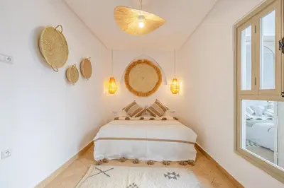 a bedroom with a bed and a window at Riad Agan Exclusive with New Heated Pool and Breakfast included in Marrakech