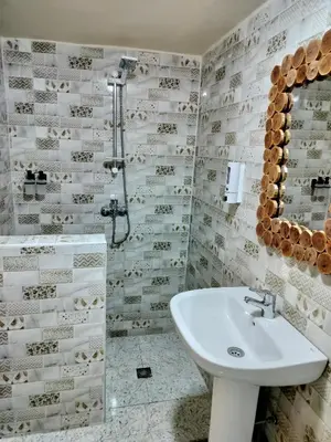 a bathroom with a sink and a shower at RIAD MAMAHOUSE in Marrakech