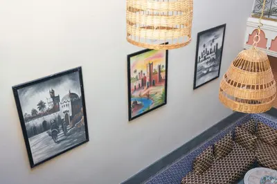 a group of framed pictures hanging on a wall at RIAD MAMAHOUSE in Marrakech