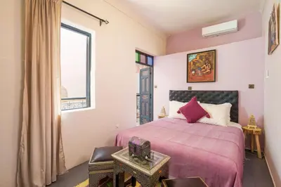 a bedroom with a bed and a window at RIAD MAMAHOUSE in Marrakech