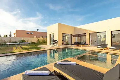 a house with a swimming pool in front of it at Villa Victoria, piscine Chauffée, sans vis à vis in Marrakech