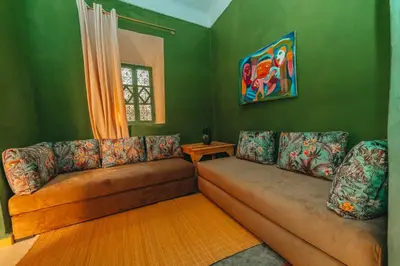a living room with a couch and a table at Hotel & Riad Veridis in Marrakech