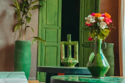 a group of vases sitting on a table with flowers in them at Hotel & Riad Veridis in Marrakech