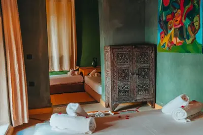 a room with an old wooden cabinet and two dolls at Hotel & Riad Veridis in Marrakech