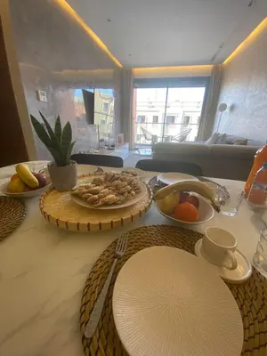 a table with plates of food on top of it at Appartement 2 ch in Marrakech