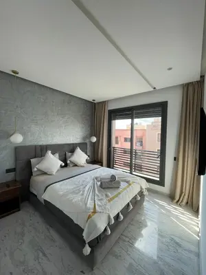 a bedroom with a large bed and a large window at Appartement 2 ch in Marrakech
