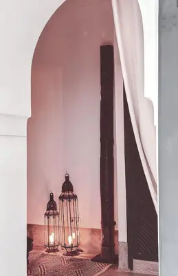 two lanterns are sitting in a room with a staircase at Riad Atay in Marrakech