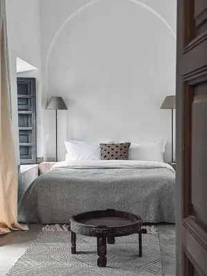 a bedroom with a bed and a coffee table at Riad Atay in Marrakech
