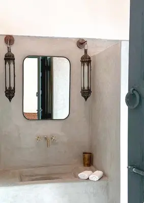 a bathroom with a mirror and a sink at Riad Atay in Marrakech