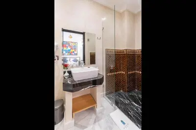 a bathroom with a sink and a shower at Riad Atlas Palace & SPA in Marrakech