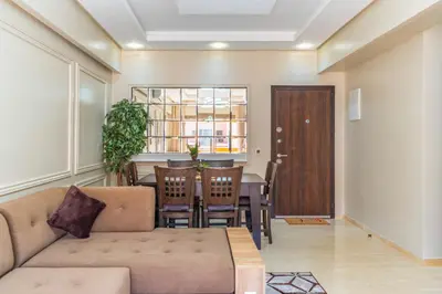 a living room with a couch and a table at Les Palmier de targa, Romantic appartement in Marrakech