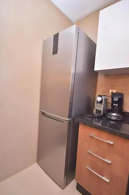a stainless steel refrigerator in a kitchen at Appartement Prestigia Golf City Marrakech in Marrakech