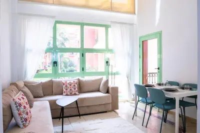 a living room with a couch and a table at Duplex Majorelle Marrakech in Marrakech