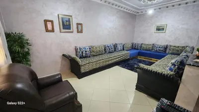 a living room with couches and a blue couch at Appartement C à 7 min de l’aéroport de Marrakech in Marrakech
