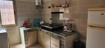 a kitchen with a stove and a counter top at Appartement C à 7 min de l’aéroport de Marrakech in Marrakech