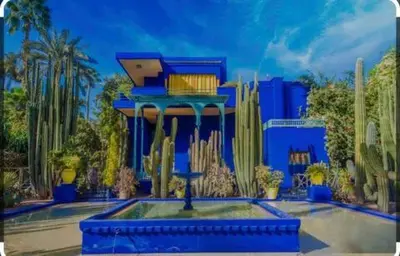 a painting of a blue building with cacti at Appartement C à 7 min de l’aéroport de Marrakech in Marrakech