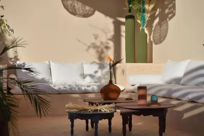a living room with a couch and two tables at Riad Palau Marrakech in Marrakech