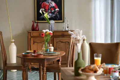 a dining room with a table and chairs and a tableablish at Riad Palau Marrakech in Marrakech
