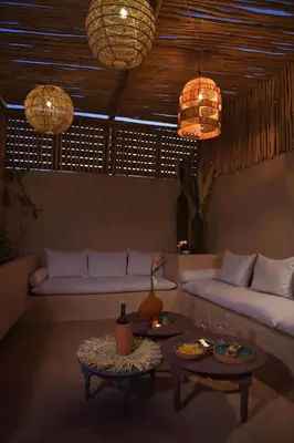a living room with a couch and two tables at Riad Palau Marrakech in Marrakech
