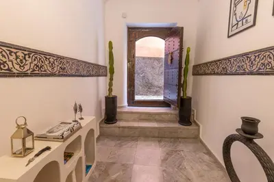 a room with a hallway with a window and a table at Riad Dar Belhaj in Marrakech