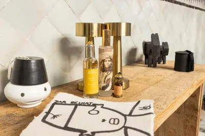 a wooden table with two bottles of oil and a lamp at Riad Dar Belhaj in Marrakech