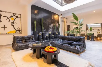 a living room with a leather couch and a table at Riad Dar Belhaj in Marrakech