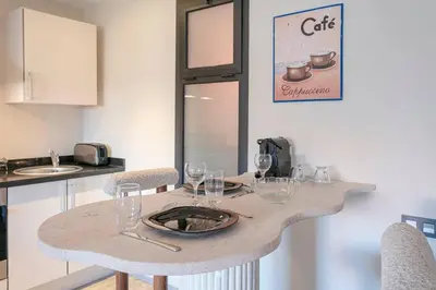 a table with wine glasses on it in a kitchen at Majestic Splendor - Marrakech Centre in Marrakech