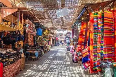 an alley in a market with many different shops at Majestic Splendor - Marrakech Centre in Marrakech