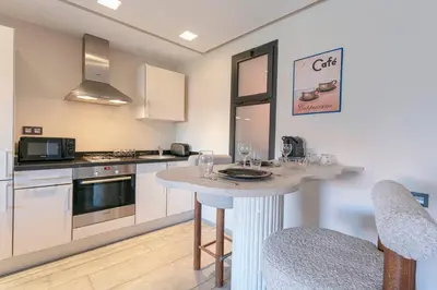 a kitchen with a table with glasses on it at Majestic Splendor - Marrakech Centre in Marrakech