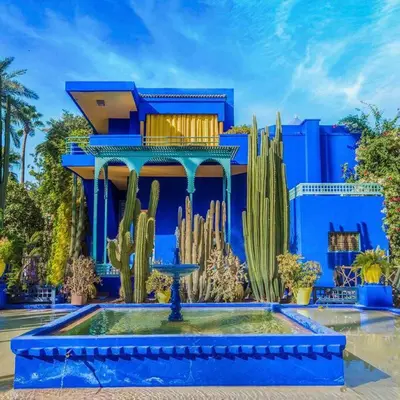a blue building with a cactus and a house at Majestic Splendor - Marrakech Centre in Marrakech