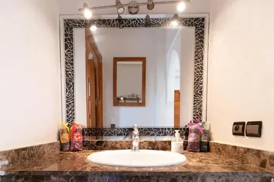 a bathroom with a sink and a large mirror at Royal mirage villa(families only) in Marrakech