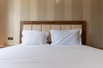 a bed with white sheets and pillows at Royal mirage villa(families only) in Marrakech
