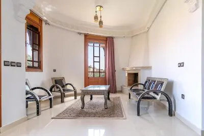 a room with four chairs and a table and a fireplace at Royal mirage villa(families only) in Marrakech