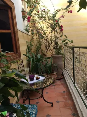 a balcony with a table and some plants at Riad Aquarelle By GE in Marrakech