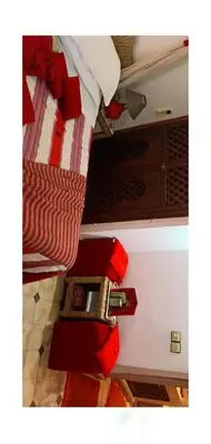 a close up of a bed with red pulls at Riad Aquarelle By GE in Marrakech