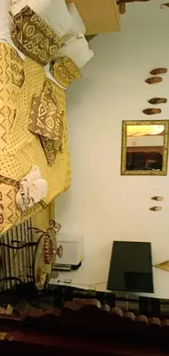 a corner of a room with a bed and a microwave at Riad Aquarelle By GE in Marrakech