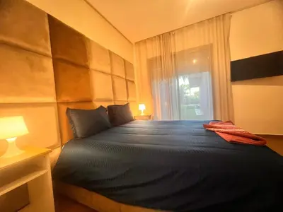 a bedroom with a large bed with a window at Opale CITY GOLF Luxe Apart 3 Rooms in Marrakech