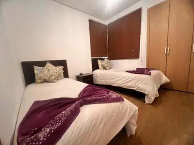 two beds in a room with purple blankets on them at Opale CITY GOLF Luxe Apart 3 Rooms in Marrakech