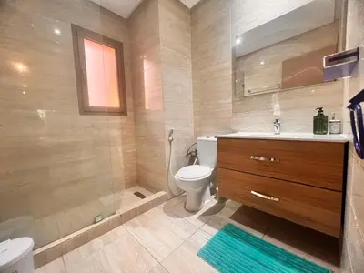 a bathroom with a toilet and a sink and a shower at Opale CITY GOLF Luxe Apart 3 Rooms in Marrakech
