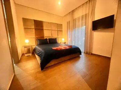 a bedroom with a bed and a large window at Opale CITY GOLF Luxe Apart 3 Rooms in Marrakech