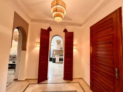a hallway with two wooden doors and an entry way at Villa 1 by Majestic Properties in Marrakech