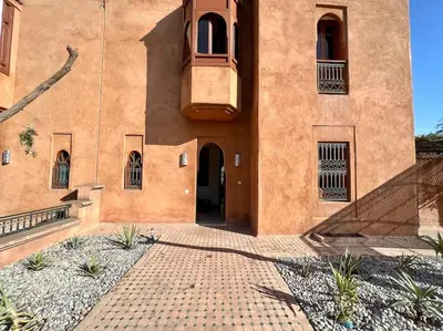a building with a balcony on the side of it at Villa 1 by Majestic Properties in Marrakech