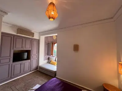 a living room with a couch and a television at Villa 1 by Majestic Properties in Marrakech